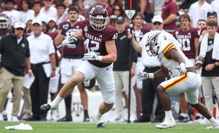 Sep 16, 2023; College Station, Texas, USA; Texas A&M Aggies tight end Max Wright (42) makes a reception as Louisiana Monroe Warhawks linebacker Travor Randle (4) defends during the first quarter at Kyle Field.